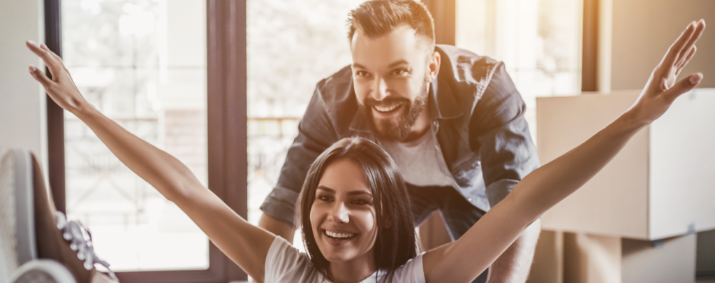 man standing over woman, her arms outstretched in chair