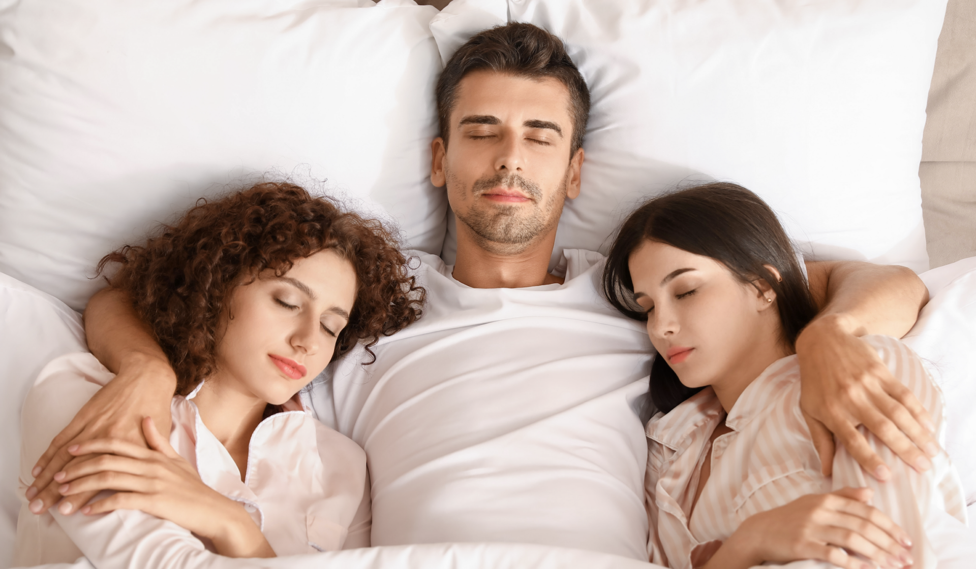 man with two women in bed